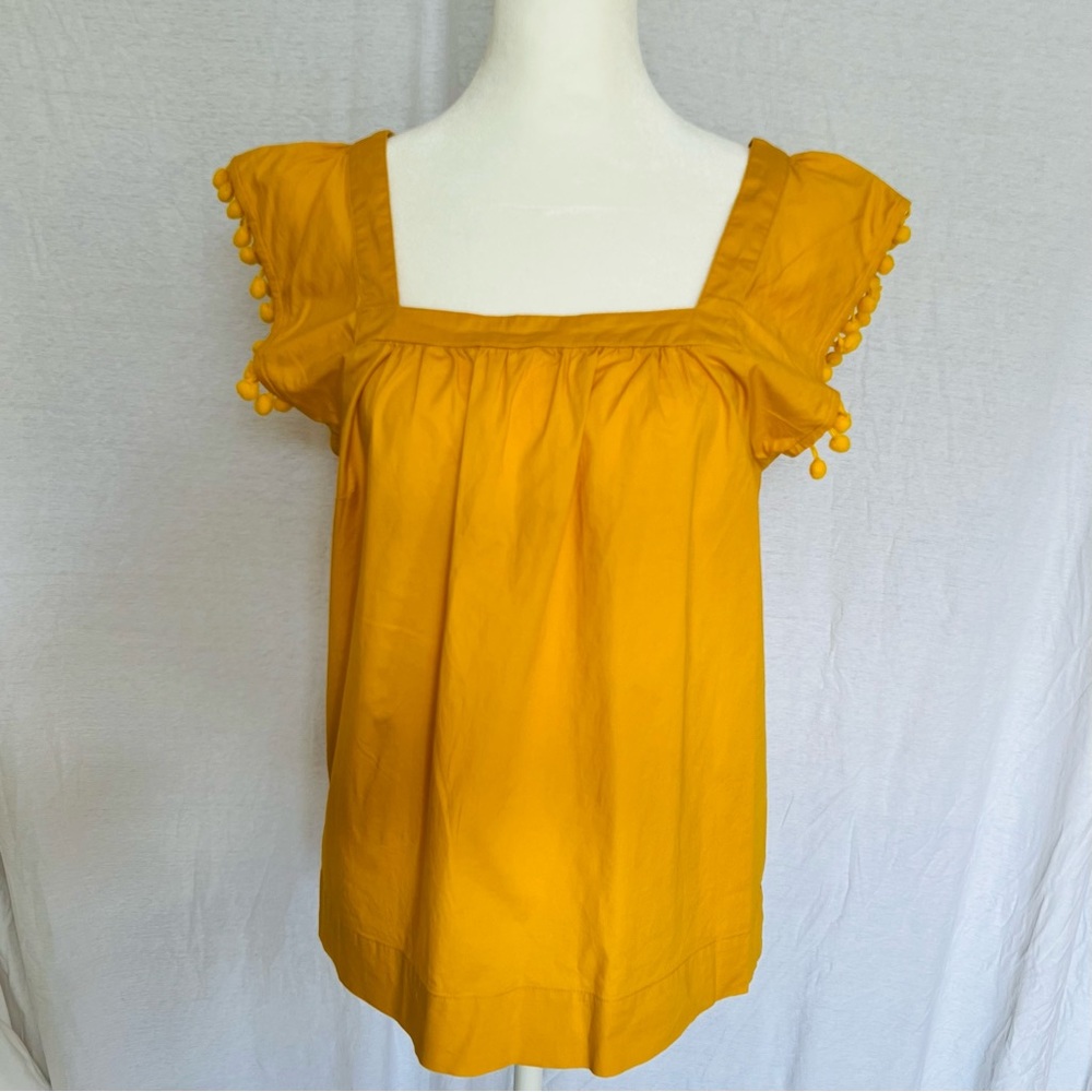 J Crew flutter sleeve Pom Pom detail yellow top in size 4. Fits like a small
